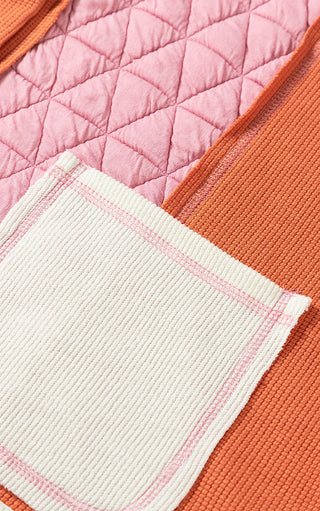 Close up view of jacket pocket showing pink quilted fabric, and ivory and orange waffle knit