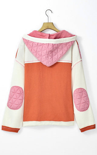Back view of the Charleston Charm Jacket in apricot and ivory waffle knit with pink quilted contrast on a hanger