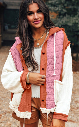 Woman wearing the Charleston Charm Jacket in apricot and ivory waffle knit with pink quilted contrast, styled with brown shorts and layered necklaces.