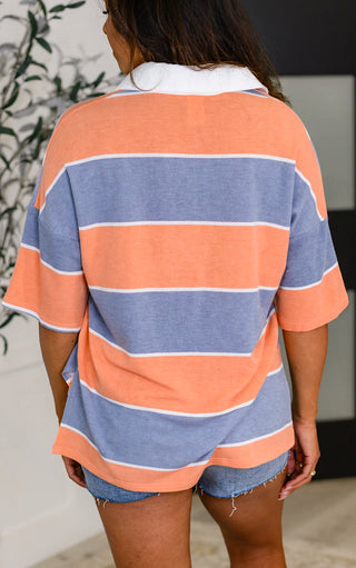 Back  view of model wearing preppy striped top in orange and blue with white collar