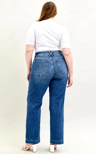 Back view of curvy Model wearing Everly Wide-Legged Jeans by Judy Blue with a white tee, showcasing the wide-leg silhouette and 4-way stretch denim.