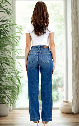 Model wearing Everly Wide-Legged Jeans by Judy Blue with a white tee, back view showcasing the wide-leg silhouette and 4-way stretch denim.