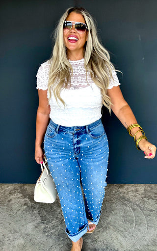 Model wearing Blakeley pearl-studded cropped jeans with white lace top and sunglasses, straight leg denim with pearl accents.