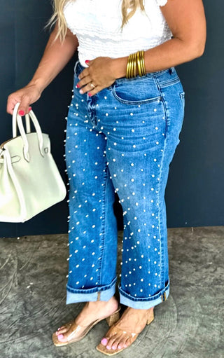 Side view Close-up of Blakeley pearl-studded cropped jeans, straight leg denim with riveted pearl details.