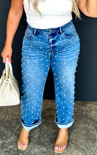 Close-up of Blakeley pearl-studded cropped jeans, straight leg denim with riveted pearl details.