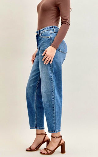 Close-up side angle of Arabella Soft Barrel Cut Jeans by Judy Blue highlighting smooth fit and soft barrel cut shape with a brown top and heels.