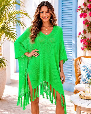 Woman wearing a green crochet fringe cover-up in a tropical setting
