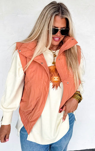 Model showing Highland Cow cozy sweatshirt with rust vest, highlighting embroidered western cow detail.