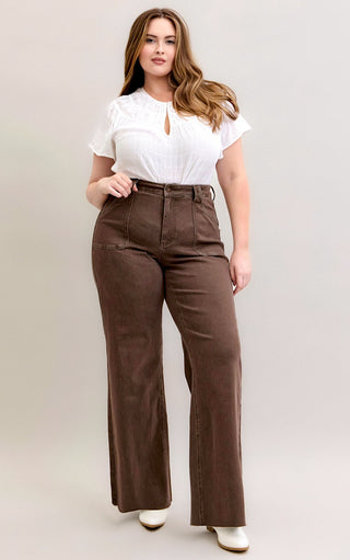 Curvy model wearing Judy Blue Chestnut Brown Wide Leg Jeans, styled with white top and boots.