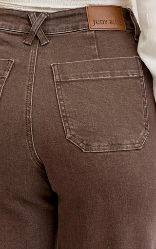 Close-up of Judy Blue Chestnut Brown Wide Leg Jeans showing back patch pockets and leather logo tag.