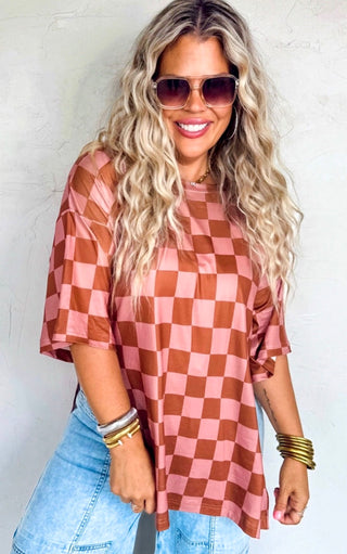 Woman wearing a checkered shirt and sunglasses against a white background