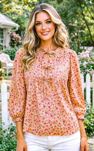 Woman wearing a feminine floral blouse in a garden setting