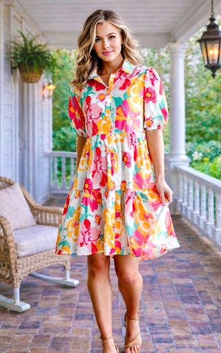 Woman wearing a colorful floral dress on a porch