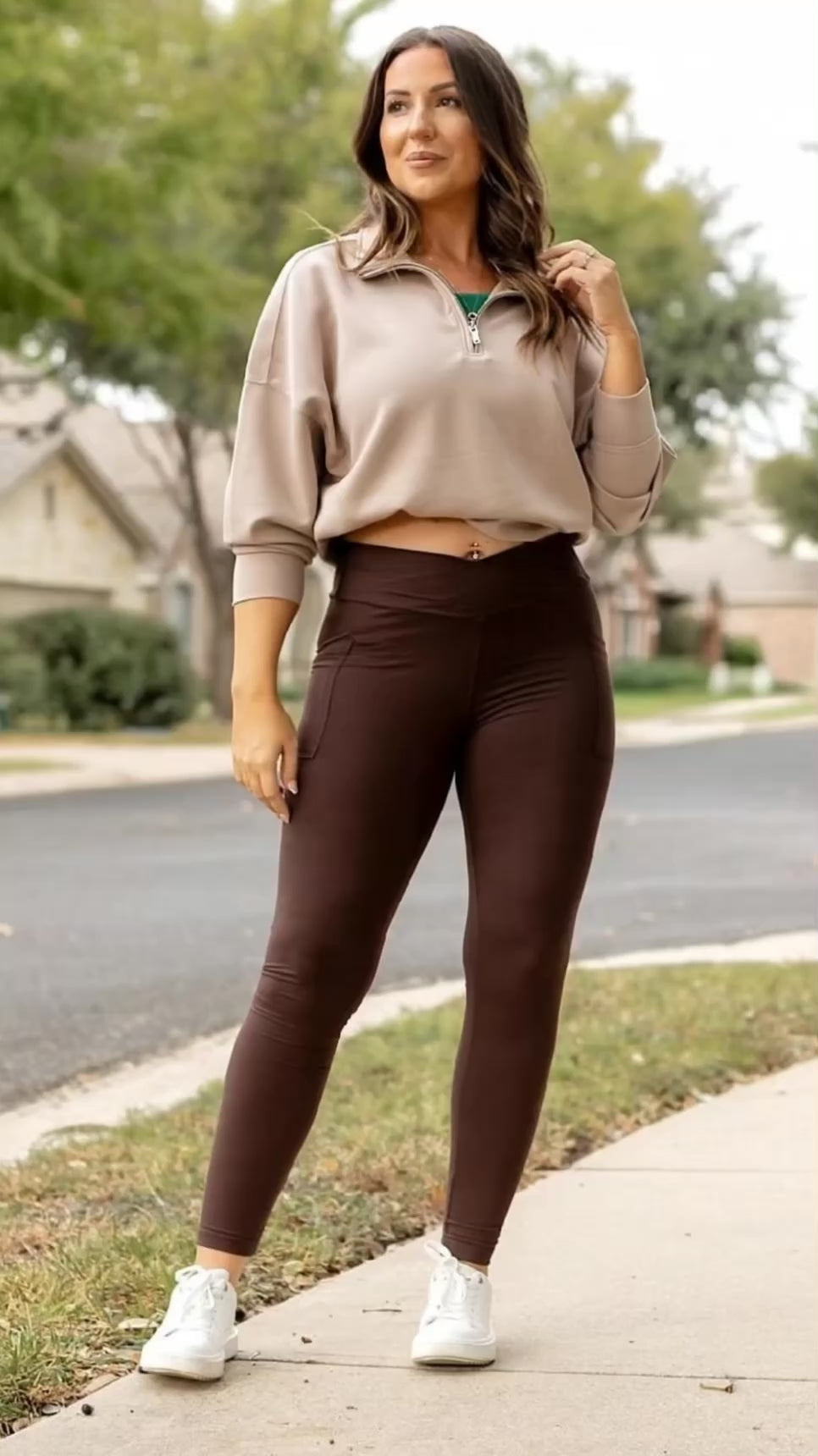 Video of Woman wearing Blissful Brown Crossover Leggings with crisscross waistband, styled with a taupe sweatshirt and white sneakers.