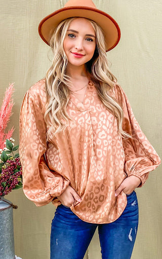 Silky bronze animal print top on blonde female wearing a hat and jeans