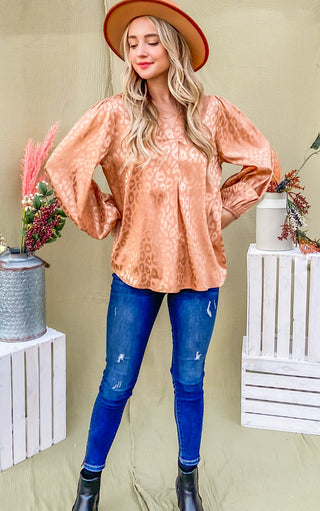 Silky bronze animal print top on blonde female wearing a hat and jeans